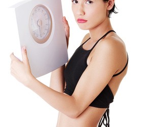 Frustrated woman with scale