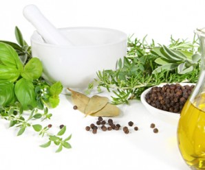 Mortar and pestle with fresh herbs and spices.